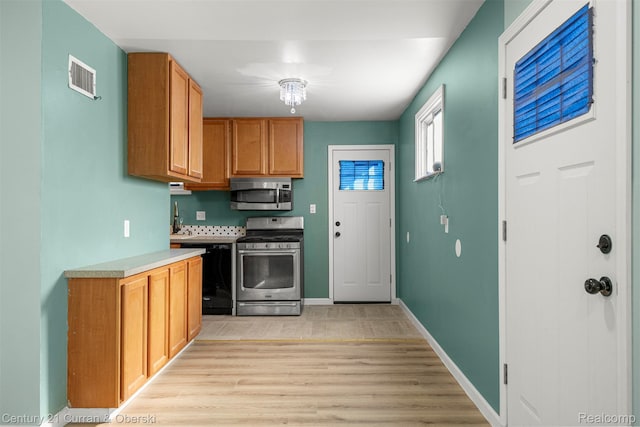 17295 Dora St, Melvindale, MI 48122 - kitchen with stainless steel appliances, light wood-style floors, and light countertops