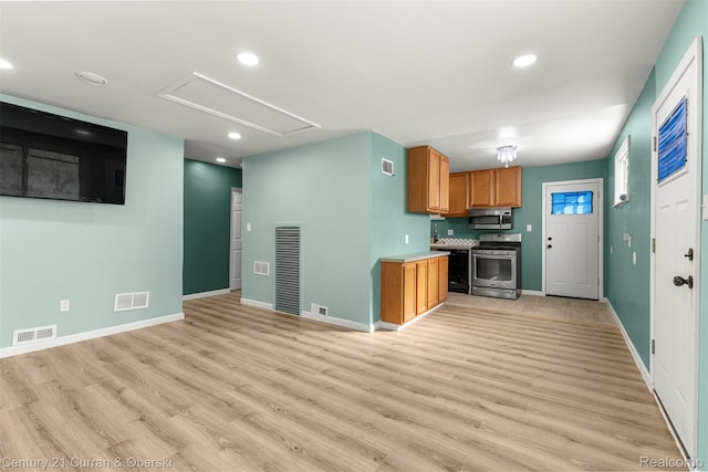 17295 Dora St, Melvindale, MI 48122 - kitchen featuring appliances with stainless steel finishes, light wood finished floors, recessed lighting, brown cabinetry, and light countertops