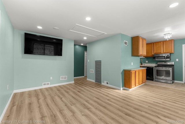 17295 Dora St, Melvindale, MI 48122 - kitchen with appliances with stainless steel finishes, light wood finished floors, recessed lighting, light countertops, and brown cabinetry