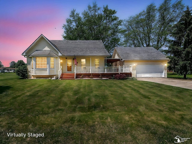 4775 Huron Ave, Newport, MI 48166 - view of front facade with an attached garage, concrete driveway, a porch, and a yard