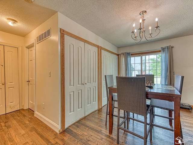 4775 Huron Ave, Newport, MI 48166 - dining space with wood finished floors, a chandelier, and a textured ceiling