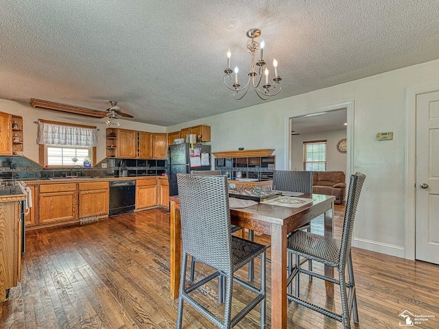 4775 Huron Ave, Newport, MI 48166 - dining space with a textured ceiling, dark wood-style flooring, healthy amount of natural light, a chandelier, and ceiling fan