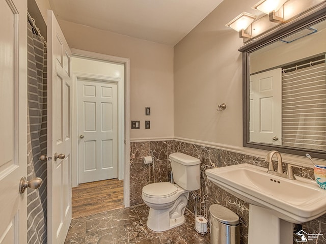 4775 Huron Ave, Newport, MI 48166 - bathroom with marble look tiles, a wainscoted wall, and tile walls