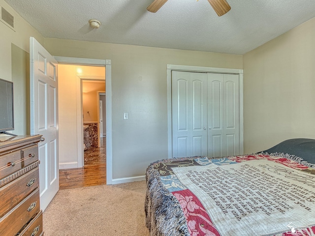 4775 Huron Ave, Newport, MI 48166 - bedroom with light colored carpet, a closet, a textured ceiling, and a ceiling fan