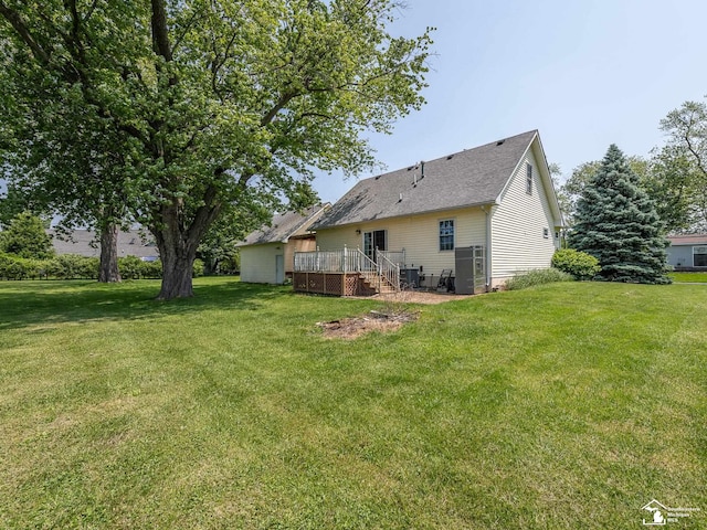 4775 Huron Ave, Newport, MI 48166 - rear view of house featuring a wooden deck, a lawn, and roof with shingles