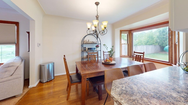 10 Covell Ave NW, Grand Rapids, MI 49504 - dining area featuring a chandelier, plenty of natural light, and light wood-style floors