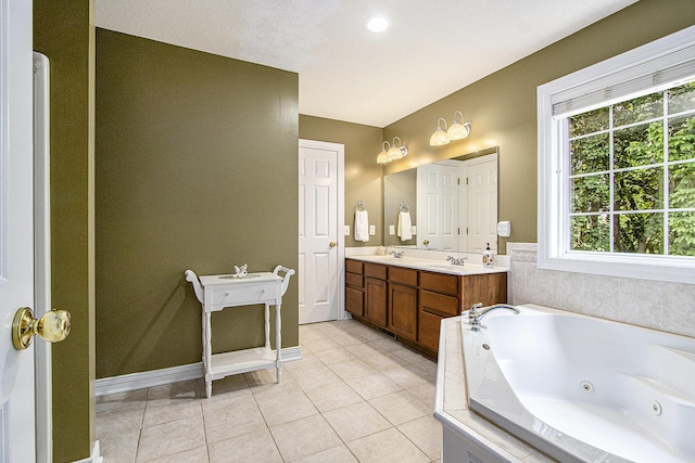 7853 Clydesdale Ave, Kalamazoo, MI 49009 - bathroom featuring double vanity, a jetted tub, and tile patterned floors