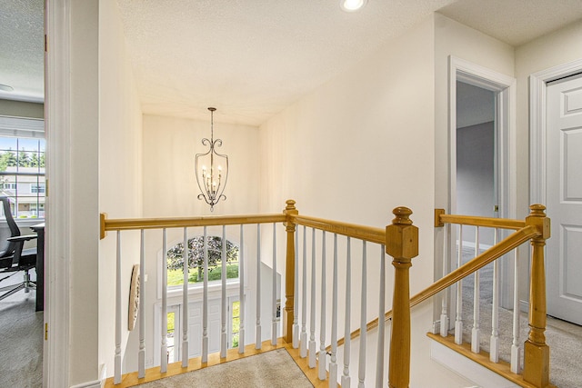 7853 Clydesdale Ave, Kalamazoo, MI 49009 - stairs featuring healthy amount of natural light, a chandelier, a textured ceiling, recessed lighting, and carpet