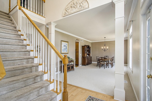 7853 Clydesdale Ave, Kalamazoo, MI 49009 - entrance foyer featuring stairway, wood finished floors, ornamental molding, a chandelier, and ornate columns