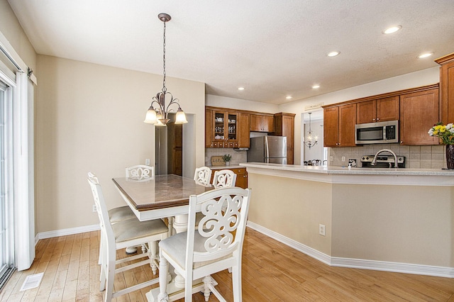 7853 Clydesdale Ave, Kalamazoo, MI 49009 - dining room with light wood finished floors, a chandelier, and recessed lighting
