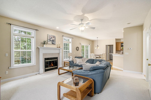 7853 Clydesdale Ave, Kalamazoo, MI 49009 - living room with light carpet, a premium fireplace, ceiling fan, and a textured ceiling