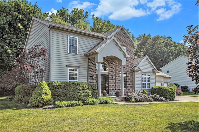 7853 Clydesdale Ave, Kalamazoo, MI 49009 - traditional-style house with a front lawn, brick siding, and driveway