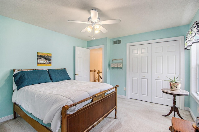 7853 Clydesdale Ave, Kalamazoo, MI 49009 - bedroom featuring light colored carpet, a closet, a textured ceiling, and ceiling fan