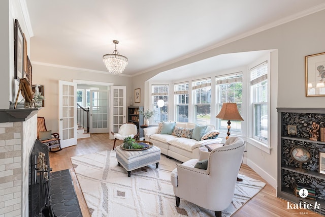 1002 Benjamin Ave SE, Grand Rapids, MI 49506 - living room featuring plenty of natural light, ornamental molding, light wood finished floors, and a chandelier