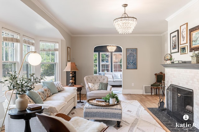 1002 Benjamin Ave SE, Grand Rapids, MI 49506 - living area with a chandelier, healthy amount of natural light, crown molding, wood finished floors, and a brick fireplace