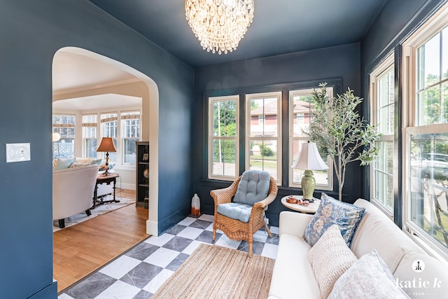 1002 Benjamin Ave SE, Grand Rapids, MI 49506 - sitting room with arched walkways, plenty of natural light, a chandelier, and tile patterned floors