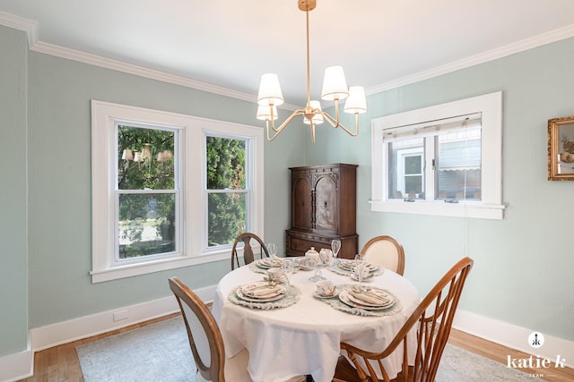 1002 Benjamin Ave SE, Grand Rapids, MI 49506 - dining space with a chandelier, light wood-style floors, and ornamental molding