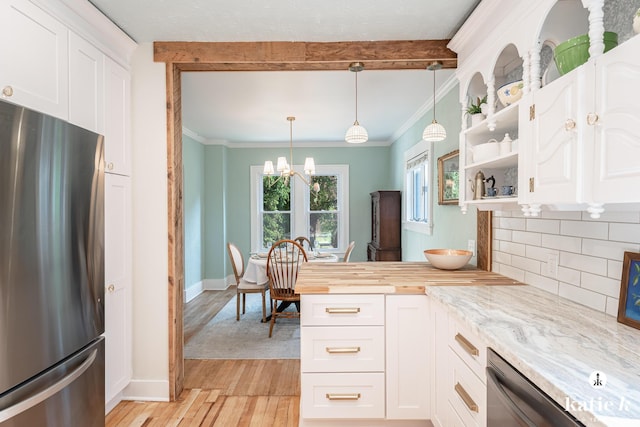1002 Benjamin Ave SE, Grand Rapids, MI 49506 - kitchen featuring stainless steel appliances, light wood-style flooring, white cabinetry, tasteful backsplash, and a chandelier