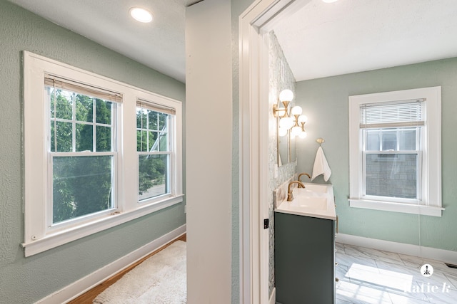 1002 Benjamin Ave SE, Grand Rapids, MI 49506 - bathroom with vanity and baseboards
