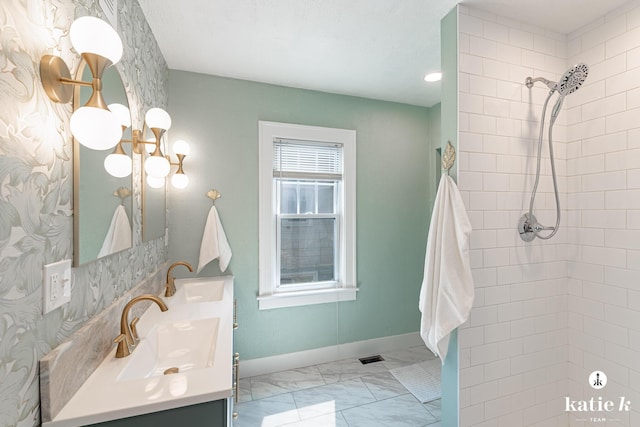 1002 Benjamin Ave SE, Grand Rapids, MI 49506 - full bathroom featuring vanity, tiled shower, and marble look tiles