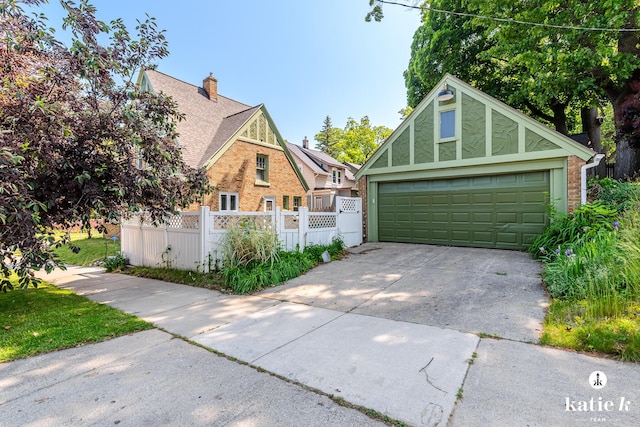 1002 Benjamin Ave SE, Grand Rapids, MI 49506 - tudor home with a garage, brick siding, a chimney, and concrete driveway