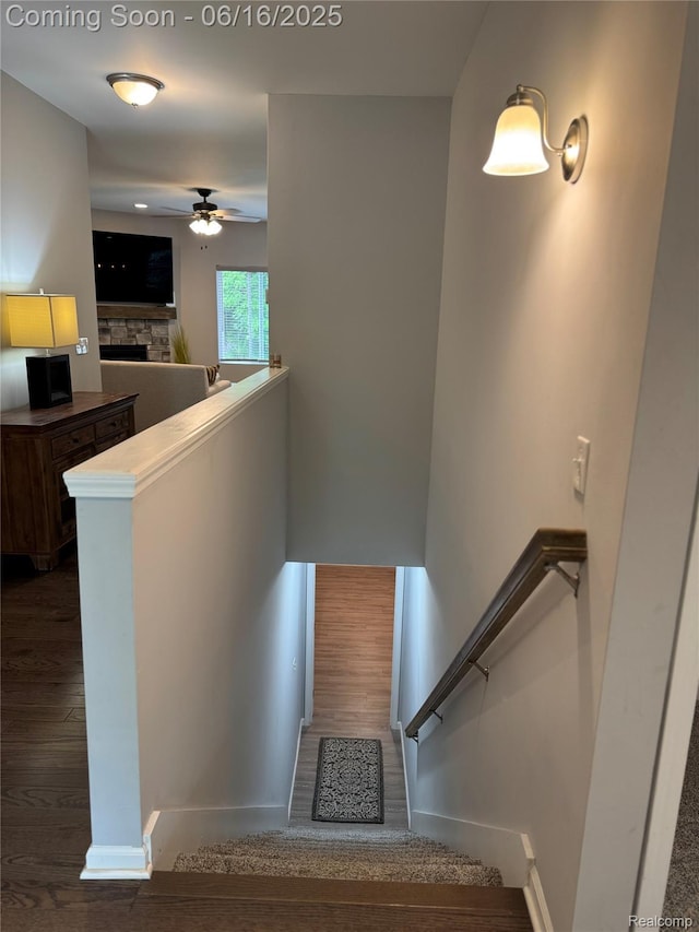 4020 Oak St, Grand Blanc, MI 48439 - stairway featuring a ceiling fan, wood finished floors, and a fireplace
