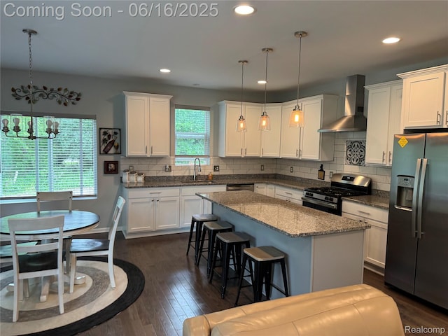 4020 Oak St, Grand Blanc, MI 48439 - kitchen with stainless steel appliances, wall chimney range hood, dark wood-style floors, white cabinetry, and recessed lighting