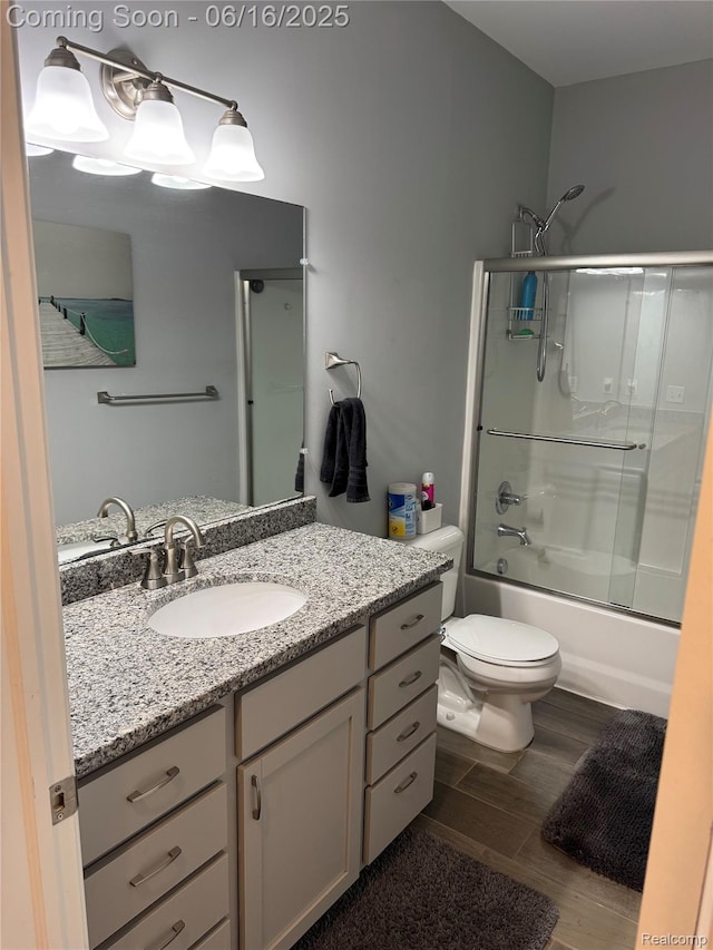 4020 Oak St, Grand Blanc, MI 48439 - full bathroom featuring vanity, shower / bath combination with glass door, and wood finished floors