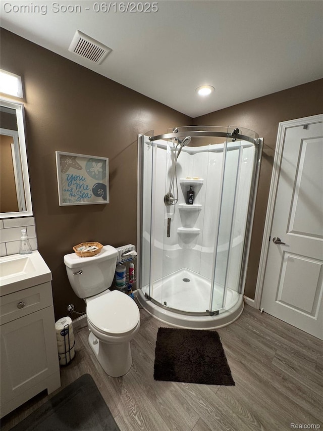 4020 Oak St, Grand Blanc, MI 48439 - full bathroom featuring wood finished floors, vanity, a shower stall, and recessed lighting