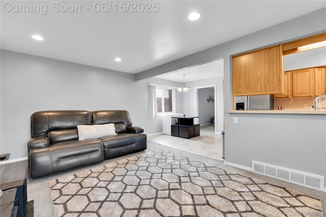 29464 Marshall St, Southfield, MI 48076 - living room with light colored carpet, recessed lighting, and a chandelier