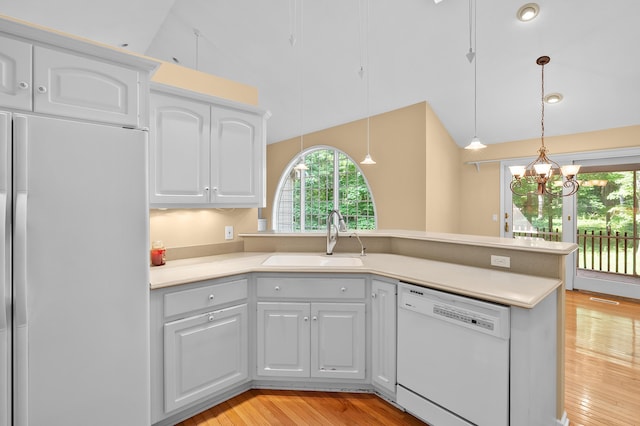 6916 Windsong Way, Kalamazoo, MI 49009 - kitchen with white appliances, light wood-style floors, white cabinets, a peninsula, and hanging light fixtures