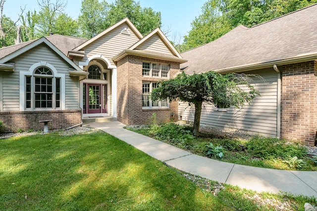 6916 Windsong Way, Kalamazoo, MI 49009 - ranch-style home featuring brick siding, a front lawn, and roof with shingles