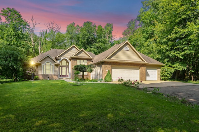 6916 Windsong Way, Kalamazoo, MI 49009 - ranch-style home with brick siding, driveway, a lawn, and a garage