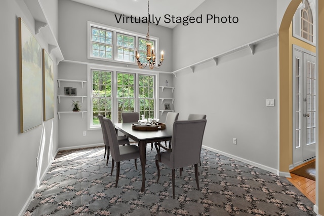 6916 Windsong Way, Kalamazoo, MI 49009 - dining room featuring a chandelier, a high ceiling, and carpet