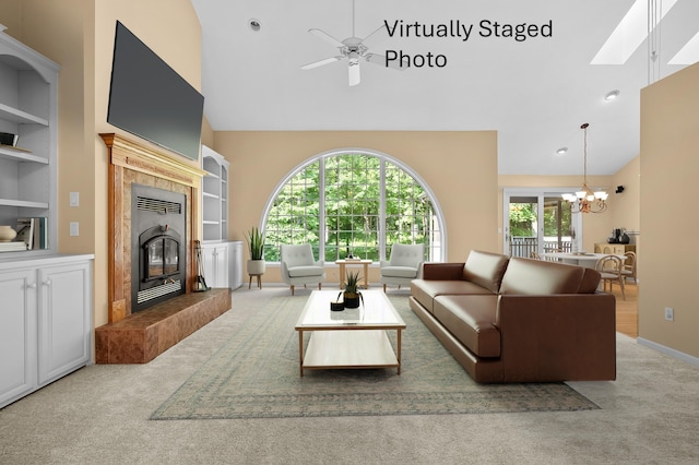 6916 Windsong Way, Kalamazoo, MI 49009 - carpeted living room with high vaulted ceiling, a fireplace, a chandelier, ceiling fan, and built in shelves