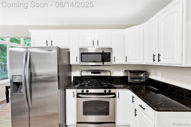 13563 Trotters Ln, Sterling Heights, MI 48313 - kitchen featuring stainless steel appliances, white cabinetry, and dark stone counters