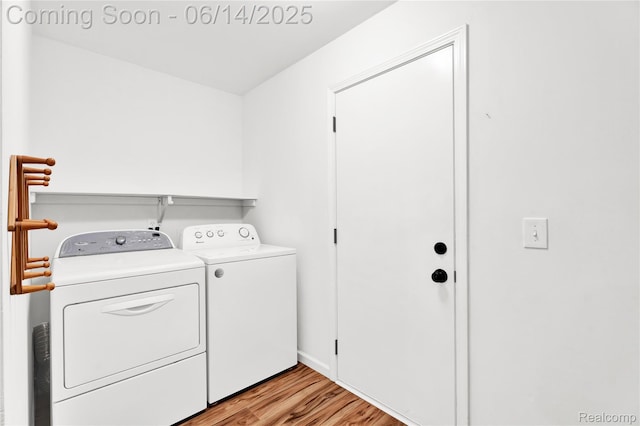 13563 Trotters Ln, Sterling Heights, MI 48313 - washroom featuring washer and clothes dryer and light wood-type flooring