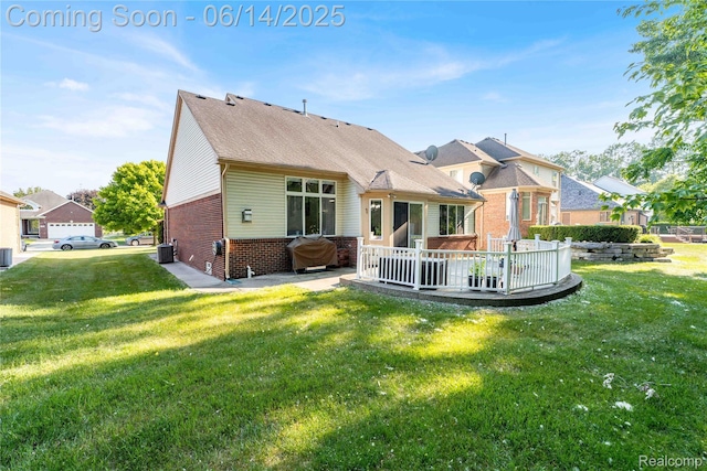 13563 Trotters Ln, Sterling Heights, MI 48313 - back of property featuring brick siding, a yard, and a deck