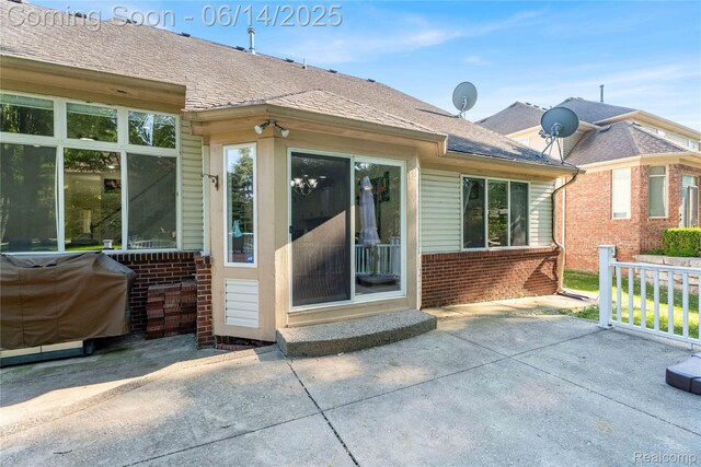 13563 Trotters Ln, Sterling Heights, MI 48313 - rear view of house with brick siding, a patio area, and roof with shingles