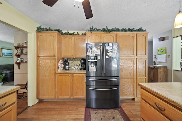 3684 W Howell Rd, Mason, MI 48854 - kitchen with stainless steel fridge, light wood-style flooring, a ceiling fan, a textured ceiling, and light countertops