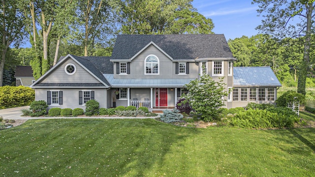 1415 Blackhawk Trl, Benton Harbor, MI 49022 - view of front of property with a porch, a front yard, a metal roof, and a shingled roof