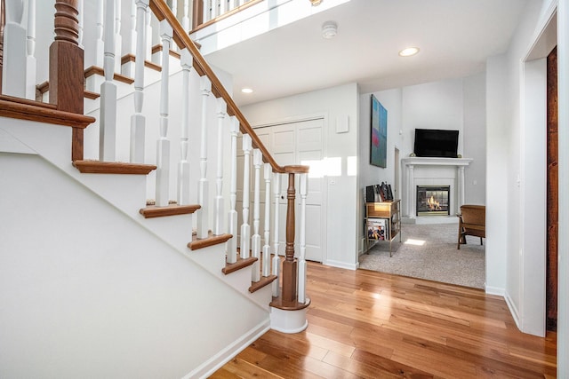 1415 Blackhawk Trl, Benton Harbor, MI 49022 - entrance foyer with hardwood / wood-style flooring, stairs, recessed lighting, and a glass covered fireplace