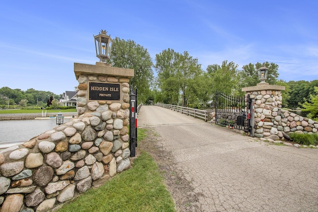 1415 Blackhawk Trl, Benton Harbor, MI 49022 - community sign featuring a gate and view of wooded area