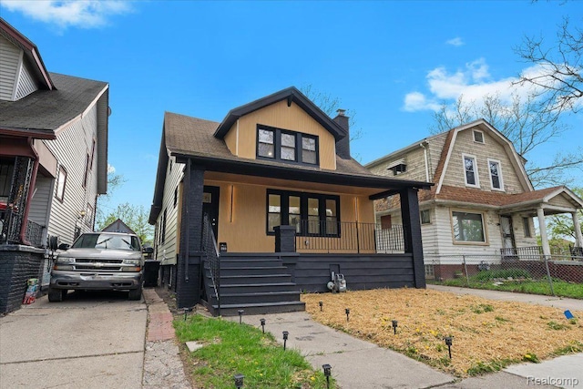 475 Algonquin St, Detroit, MI 48215 - view of front of house featuring a porch and a chimney