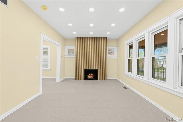475 Algonquin St, Detroit, MI 48215 - unfurnished living room featuring light carpet, recessed lighting, and a large fireplace