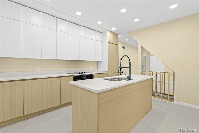 475 Algonquin St, Detroit, MI 48215 - kitchen featuring modern cabinets, recessed lighting, light brown cabinetry, a center island with sink, and light stone countertops