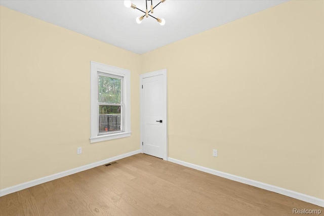 475 Algonquin St, Detroit, MI 48215 - spare room featuring a chandelier and light wood-type flooring