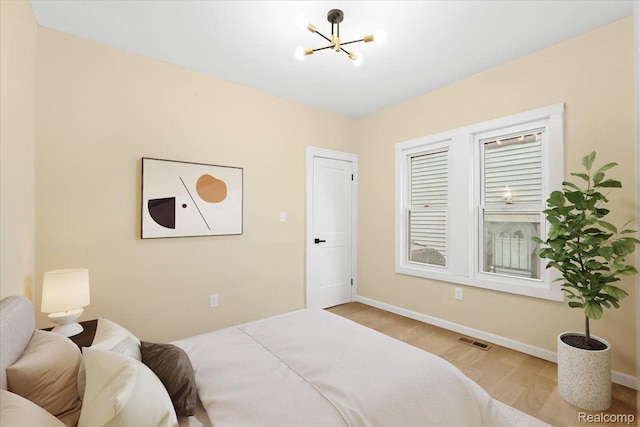 475 Algonquin St, Detroit, MI 48215 - bedroom with wood finished floors and a chandelier