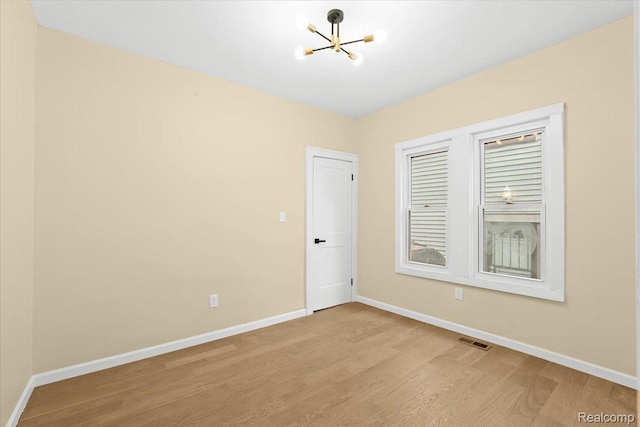 475 Algonquin St, Detroit, MI 48215 - empty room with a chandelier and light wood finished floors