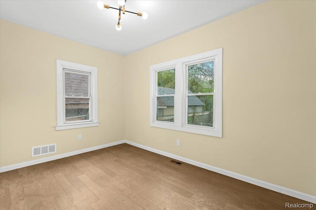 475 Algonquin St, Detroit, MI 48215 - empty room with wood finished floors and a chandelier
